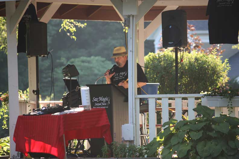Sax Magic performing solo in a white garden gazebo at a private event